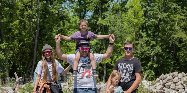 A joyful family enjoying a sunny day outdoors, captured in a lively and happy moment.
